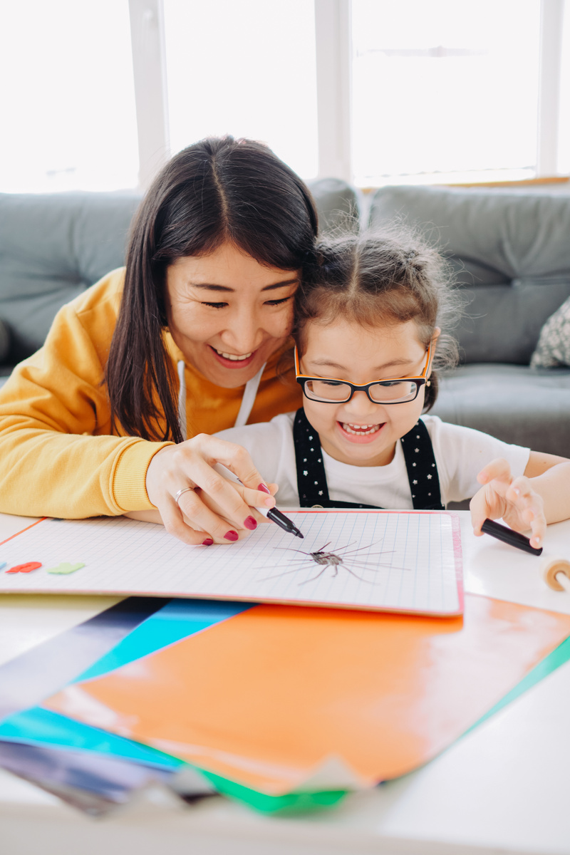 Happy Mother and Child Learning at Home 